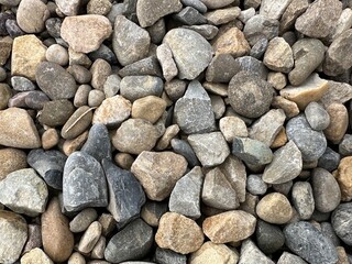 Detailed gravel road texture showing stones and earth tones