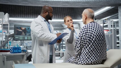 Fototapeta premium Laboratory experts analyzing a patient vitals during drug testing, evaluating treatment safety, dosage reactions and side effects in a study. Innovation and prevention in healthcare. Camera A.