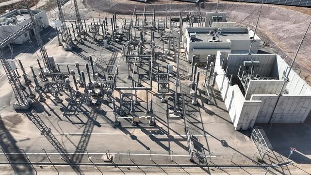 Electric power station and urban energy hub supplying electricity to the city. Industrial infrastructure and energy network under bright daylight.