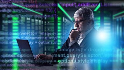 IT specialist with laptop working in server room, programming and analyzing code for cybersecurity and data management. Information Technology, Cybersecurity. © Grispb
