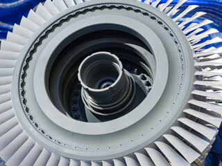 Engineering demonstrates aircraft turbine engine detail with metal blades, precision mechanics and...