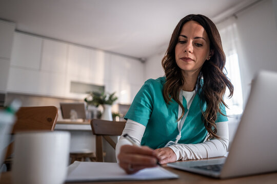 Female healthcare professional studying medicine at home