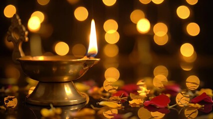 A Lit Brass Oil Lamp with a Burning Flame Surrounded by Scattered Flower Petals and Soft Golden Bokeh Lights in the Background