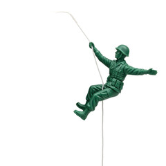 Green Plastic Toy Soldier Descending on a Rope with a Dramatic Spotlight Illumination Against a Monochromatic Gradient Background Symbolizing