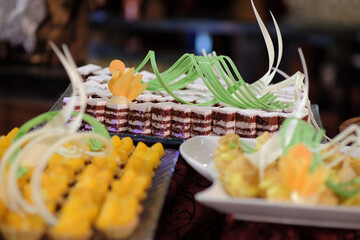 Cakes with sweet, high calorie cream topping are served as snacks.