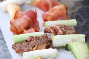Grilled kebabs with bacon, beef, and scallion