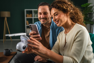 Couple setting up smart home security camera using smart phone