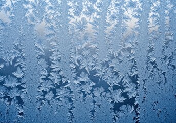 Intricate frost patterns on a window create a beautiful winter scene