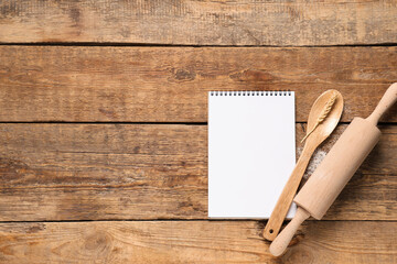 Blank recipe book with kitchen utensils and spikelet on wooden background