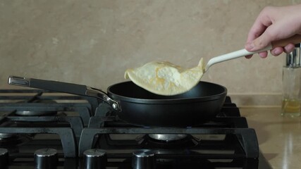 The technique of flipping pancakes in a non-stick pan. Perfect for cooking enthusiasts and beginners alike. Elevate your breakfast game with ease
