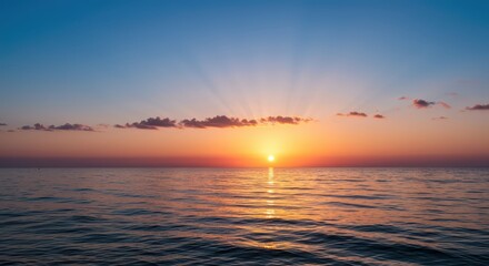 Naklejka premium Ocean horizon at sunrise with colorful sky and gentle waves.