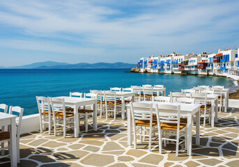 Fototapeta premium White table with chairs on the beautiful ocean view.
