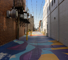 Vibrant alleyway in Benton Harbor showcases colorful street art amid historic facades, capturing the spirit of Michigan's creative community and local culture, inviting exploration and appreciation