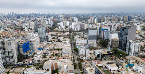 Fototapeta premium Hazy afternoon light over Lima’s coastal cityscape.