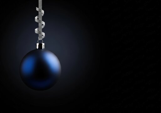 Elegant blue Christmas ornament with silver ribbon against a dark background