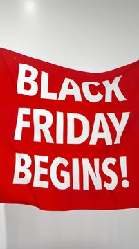 Announcement of Black Friday sales event with bold red banner, promotional graphic design, retail marketing, indoor environment, front view, consumer shopping concept