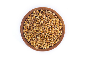 Top-down view of whole, dried coriander seeds in a rustic wooden bowl, isolated on a white background. An essential aromatic spice for cooking and culinary concepts.