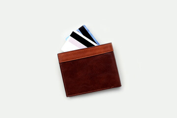Brown leather wallet with credit cards partially visible.