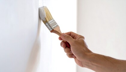 Hand painting wall with paintbrush