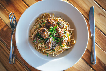 Pasta with Meatballs on a Wooden Table