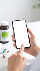 Hands holding a phone with blank screen, medicine in background