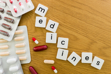 Composition with the word medicine, pills on the left and copyspace on the right