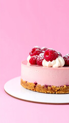 Delicious Pink Raspberry Cheesecake Topped with Fresh Berries and Cream