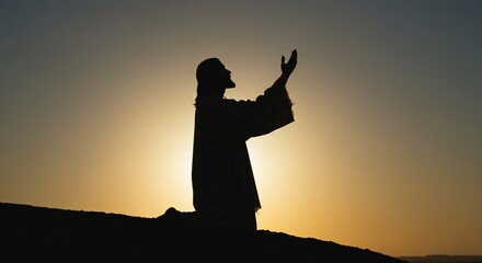 Silhouette of Jesus Praying at Sunset Religious Faith Hope Spiritual Worship Image