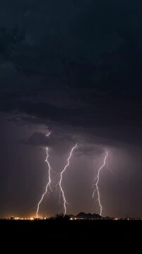 Lightning storm striking dark night sky over rural landscape, dramatic natural event, wide-angle view, atmospheric thunderstorm concept