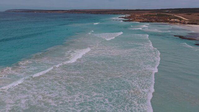 Aerial drone footage of crystal clear turquoise water at Lone Pine Beach on the Eyre Peninsula, South Australia, showcasing pristine coastline, white sand, and the untouched beauty of the southern oce
