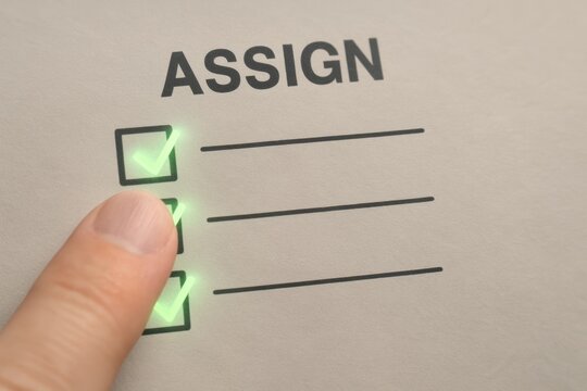 A finger checking off tasks on an assign checklist, symbolizing productivity and organization.