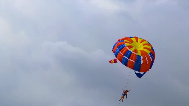 Patong Beach Phuket with parachute sport and parasailing activity Thailand.
