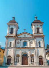 Obraz premium White church exterior with a blue sky in the background. The building has two towers
