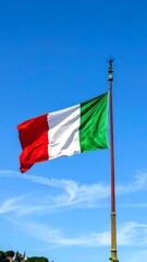 Italian flag waving in clear blue sky