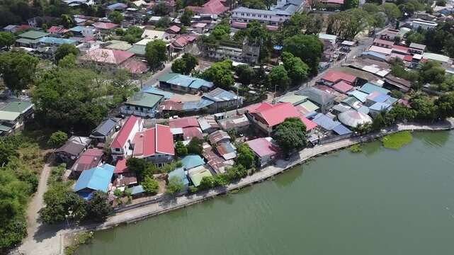 Side Left Drone Movement Capturing Barangay and Lake in San Rafael Bulacan, Philippines &mdash; Scenic 4K Aerial View of Homes, Trees, and Natural Rural Environment