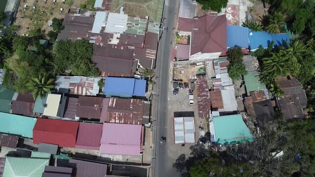 Aerial 4K Drone View of Barangay and Lake in San Rafael Bulacan, Philippines &mdash; Top Down Shot Showing Roofs, Houses, and Green Landscapes on a Bright Sunny Day, Local Village Community Scene