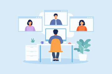 Man working from home in a video conference with colleagues on his computer screen