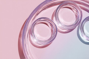 Transparent trays arranged on a soft pink and grey gradient background