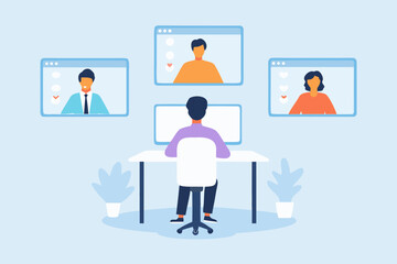 Person working from home on a video conference call with colleagues in separate windows on screen