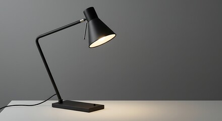 Modern Black Desk Lamp Illuminating a White Surface.