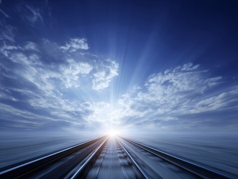 地平線の彼方へと続く線路と朝日の光が象徴する希望と未来への道