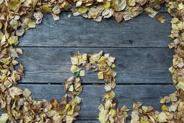 Autumn Leaves Forming Circular Pattern on Rustic Wooden Background