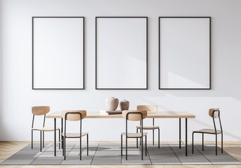 Three empty framed posters hang on a clean white wall above a wooden dining table with chairs in a minimalist interior, modern display mockup. 3D Rendering