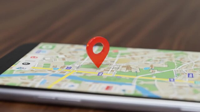 A smartphone displaying a map with a red location pin.