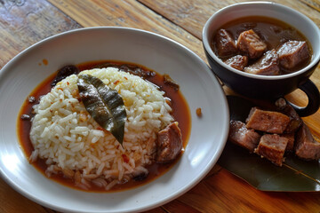 A pile of fragrant rice with pieces of meat and green onions. Simple and delicious food.