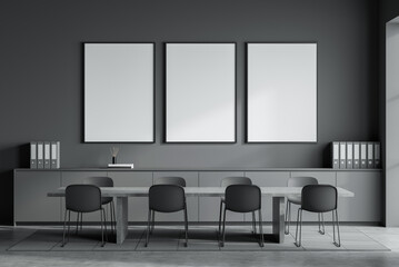 Empty modern office space with three blank posters on dark wall, minimal furniture and organized layout, clean design concept. 3D Rendering © ImageFlow