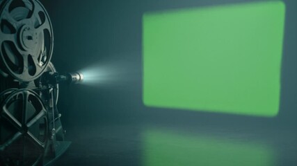 movie projector on green screen wall. projector simulating historical movie projection on green screen wall. loop - Powered by Adobe