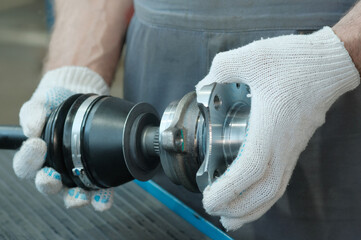 Auto parts. Car service center.Repair of the car's front suspension.The mechanic has a new drive, a...