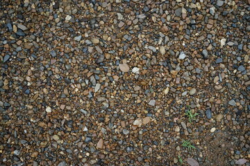 Small colorful gravel pebbles stone texture on the ground