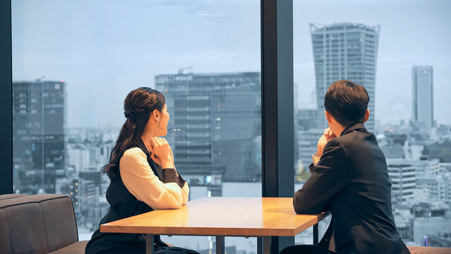 A couple watching the night view from the lounge - Powered by Adobe